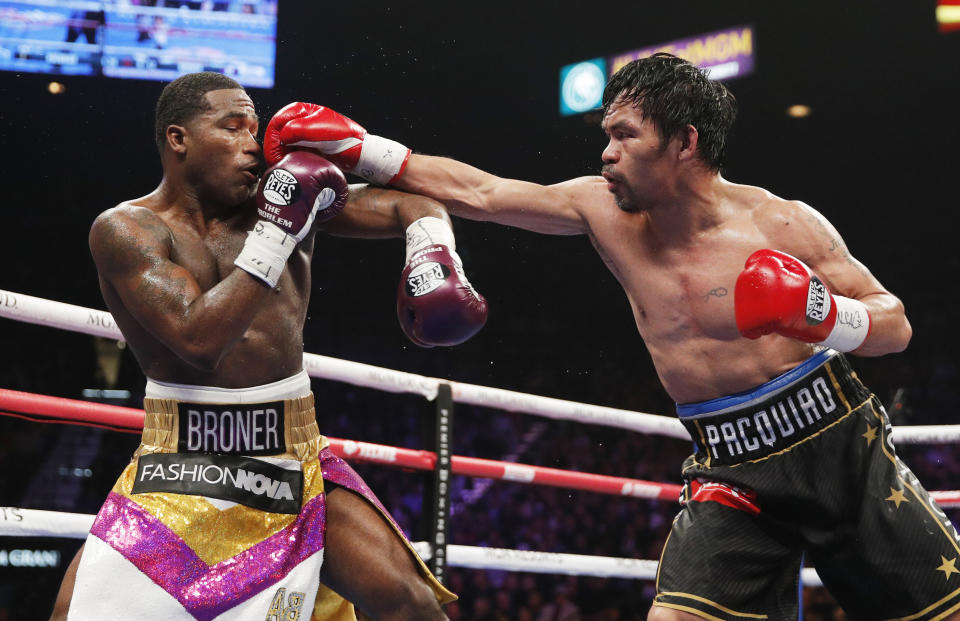 FILE - In this Saturday, Jan. 19, 2019, file photo, Manny Pacquiao, right, fights Adrien Broner in a welterweight championship bout in Las Vegas. A spokesman for Pacquiao says the famed fighter's Los Angeles home was robbed at about the time he was in the ring with rival Adrien Broner in Las Vegas. Spokesman Mike Quinn confirmed the burglary to NBC News. Los Angeles police said a burglary was reported about 4:15 p.m. Sunday, Jan. 20, 2019. in the Larchmont neighborhood. (AP Photo/John Locher, File