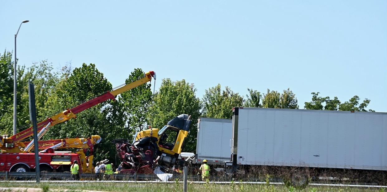 A tow truck works at the scene of a fatal crash that involved four tractor-trailers and two passenger vehicles Friday morning on Interstate 81 north of Hagerstown. At least one person was killed and multiple people were injured.