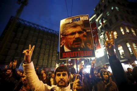 A demonstrator holds picture of Bar Association President Tahir Elci during a protest in Istanbul, Turkey, November 28, 2015. REUTERS/Osman Orsal