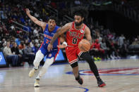 Chicago Bulls guard Coby White (0) drives on Detroit Pistons guard Jaden Ivey (23) in the first half of an NBA basketball game in Detroit, Thursday, April 11, 2024. (AP Photo/Paul Sancya)