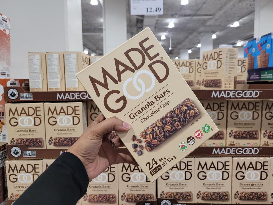 hand holding up a bulk box of madegood granola bars at costco