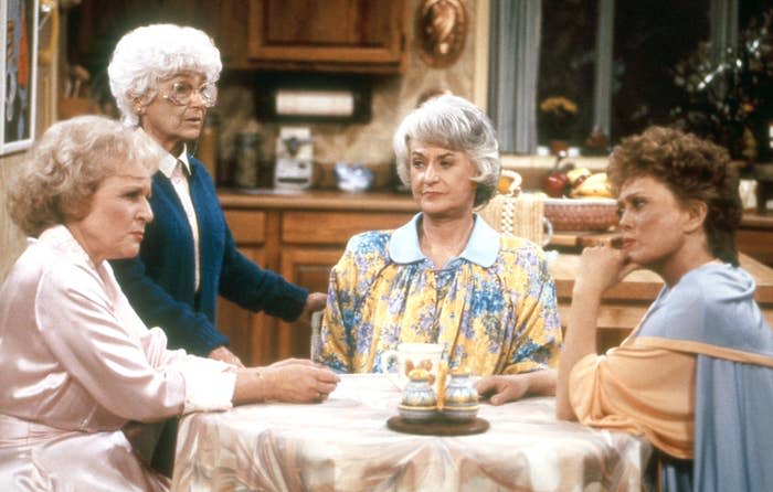 The Golden girls sitting around their kitchen table during a scene