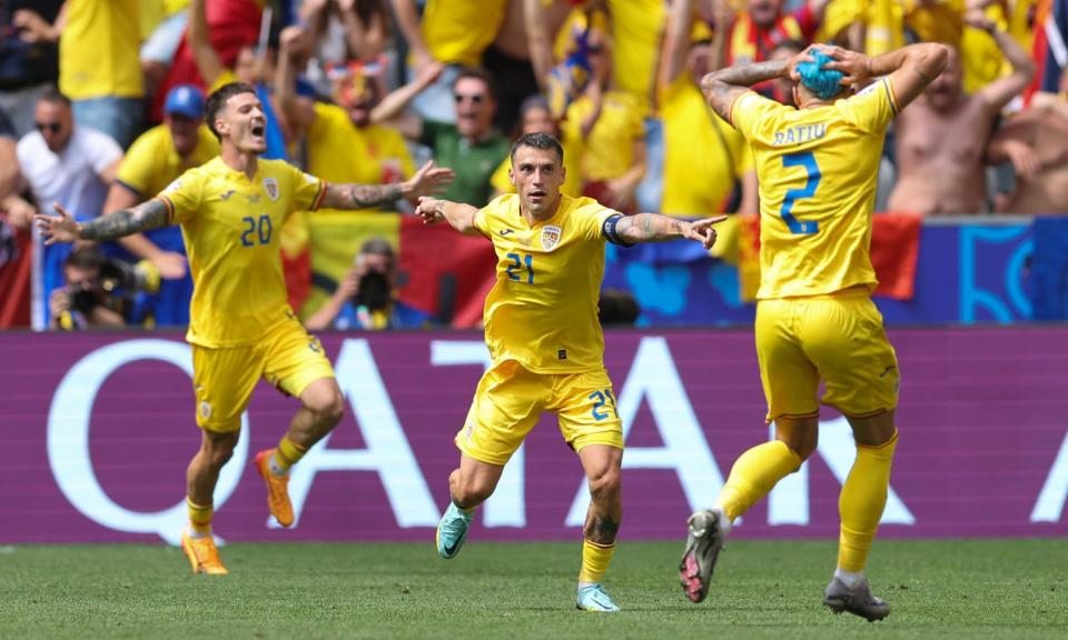 <span>Nicolae Stanciu (centre) celebrates Romania’s opening goal with Dennis Man and Andrei Ratiu.</span><span>Photograph: Catherine Ivill/AMA/Getty Images</span>