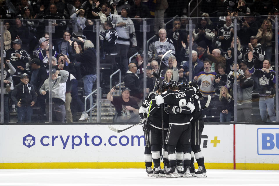 Members of the Los Angeles Kings celebrate after center Trevor Lewis (22) scored during during the first period of an NHL hockey game against the Nashville Predators, Thursday, Feb. 22, 2024, in Los Angeles. (AP Photo/Yannick Peterhans)