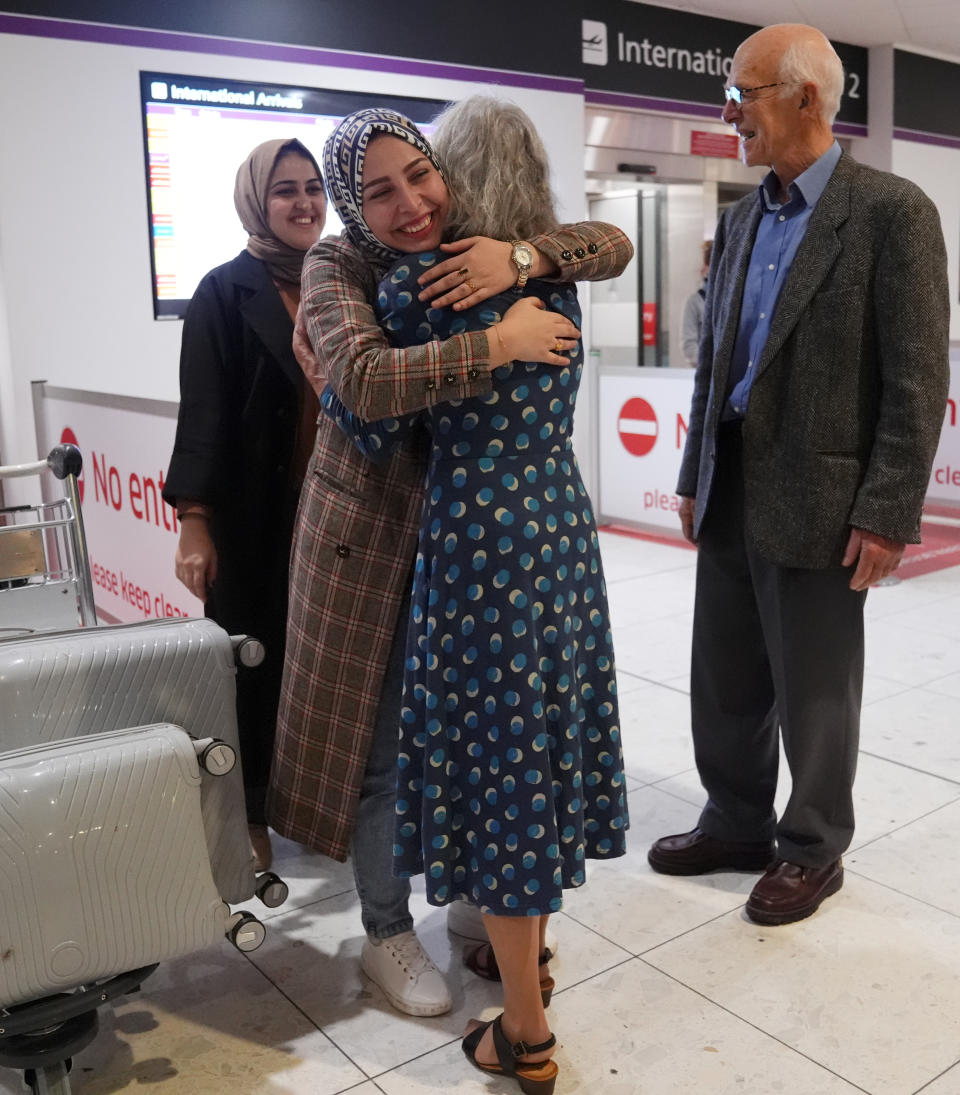 The parents of Linda Norgove, a Scottish aid worker killed in Afganistan, were at the airport to greet the students, with Lorna Norgrove hugging the women.