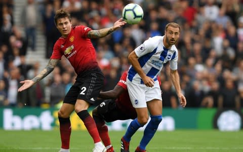 Victor Lindelof and Paul Pogba of Manchester United put pressure on Glenn Murray of Brighton - Credit: Getty