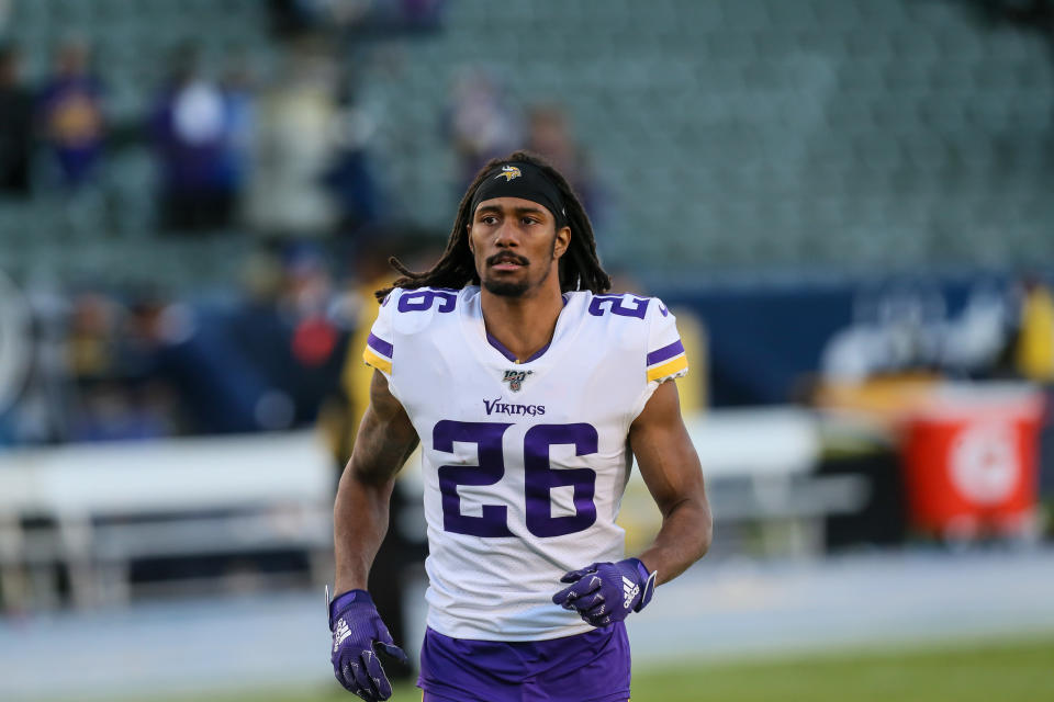 Trae Waynes jogs on the field in a Vikings uniform.