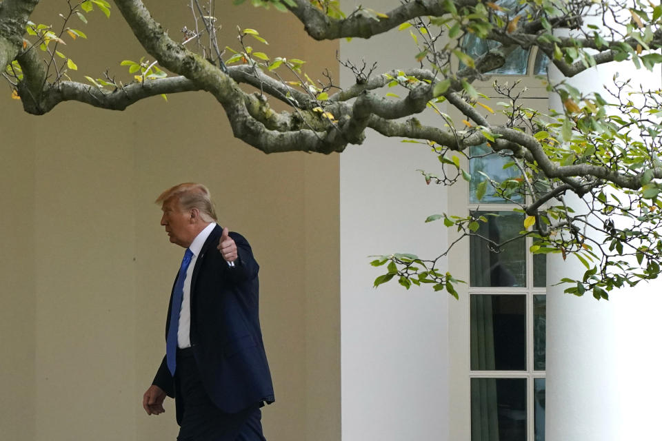 President Donald Trump gestures to members of the press as he walks to the Oval Office of the White House after visiting the Supreme Court to pay respects to Justice Ruth Bader Ginsburg, Thursday, Sept. 24, 2020, in Washington. (AP Photo/Patrick Semansky)