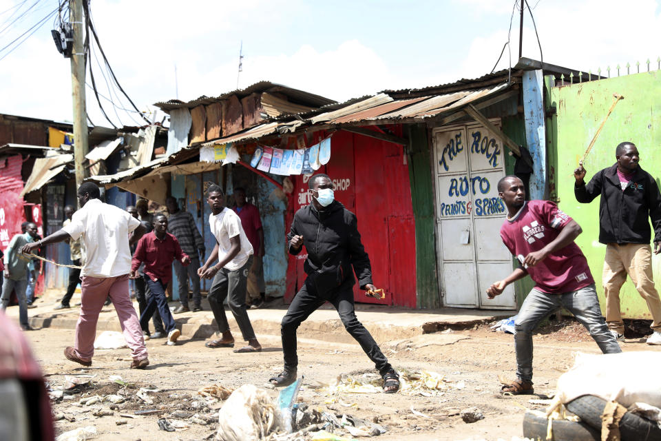 Protesters throw stones towards police officers during a mass rally called by the opposition leader Raila Odinga over the high cost of living in Kibera Slums, Nairobi, Monday, March 27, 2023. Police in Kenya are on high alert ahead of the second round of anti-government protests organized by the opposition that has been termed as illegal by the government. Police chief Japheth Koome insists that Monday's protests are illegal but the opposition leader Raila Odinga says Kenyans have a right to demonstrate.(AP Photo/Brian Inganga)