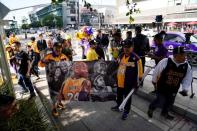 Fans gather around L.A. Live before the public memorial for NBA great Kobe Bryant, his daughter and seven others killed in a helicopter crash, at the Staples Center in Los Angeles