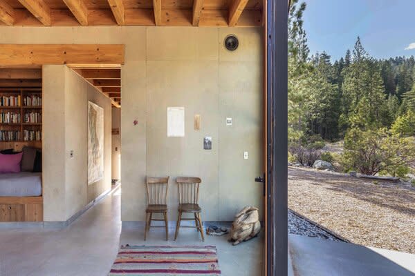 Polished concrete floors line the home, complementing the exposed beams and woodwork.