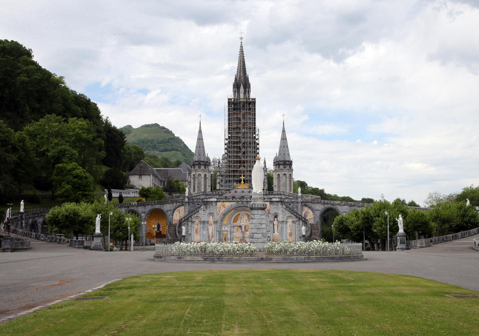 FILE - The closed Basilica of Lourdes is pictured May 8, 2020, in Lourdes, southwestern France. Pope Francis' Jesuit religious order is weighing further disciplinary measures against the Rev. Marko Ivan Rupnik following a third church investigation into allegations he used his charismatic personality and exalted status as one of the Catholic Church's preeminent religious artists to manipulate adult women into sexual activity. Mosiacs by Rev. Marko Ivan Rupnik decorate several churches and chapels, including the Lourdes basilica. (AP Photo/Bob Edme, File)