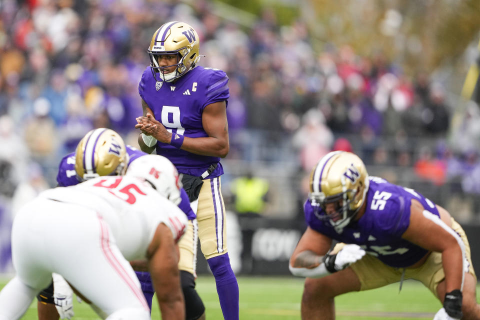 FILE - Washington quarterback Michael Penix Jr. (9) prepares for the snap against Utah during the second half of an NCAA college football game Nov. 11, 2023, in Seattle. The biggest Washington players allowed only 11 sacks this season, paving the way for Penix and No. 2 Huskies to reach the College Football Playoff and earning the Joe Moore Award as the best offensive line in the country. (AP Photo/Lindsey Wasson, File)