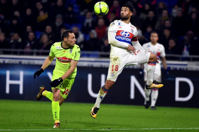 Lyon's forward Nabil Fekir (R) jumps for the ball in front of Angers' defender Vincent Manceau on January 14, 2018