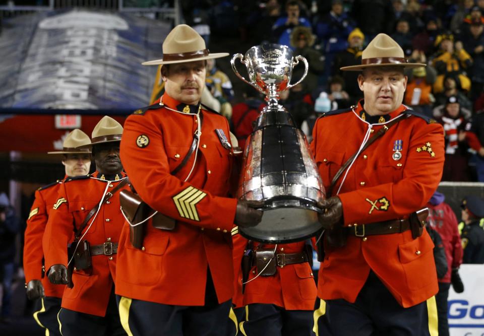 The Grey Cup is carried into the stadium by members of the Royal Canadian Mounted Police (RCMP) prior to the start of the CFL's 103rd Grey Cup championship football game between the Ottawa Redblacks and the Edmonton Eskimos in Winnipeg, Manitoba, November 29, 2015. REUTERS/Mark Blinch