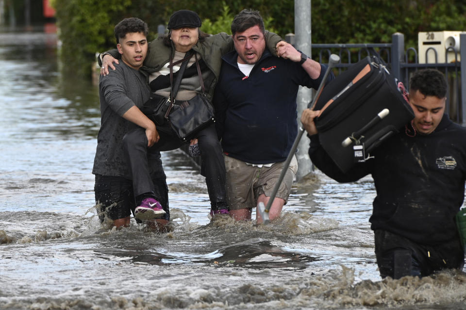 A woman is rescued from floodwater in Maribyrnong, Australia