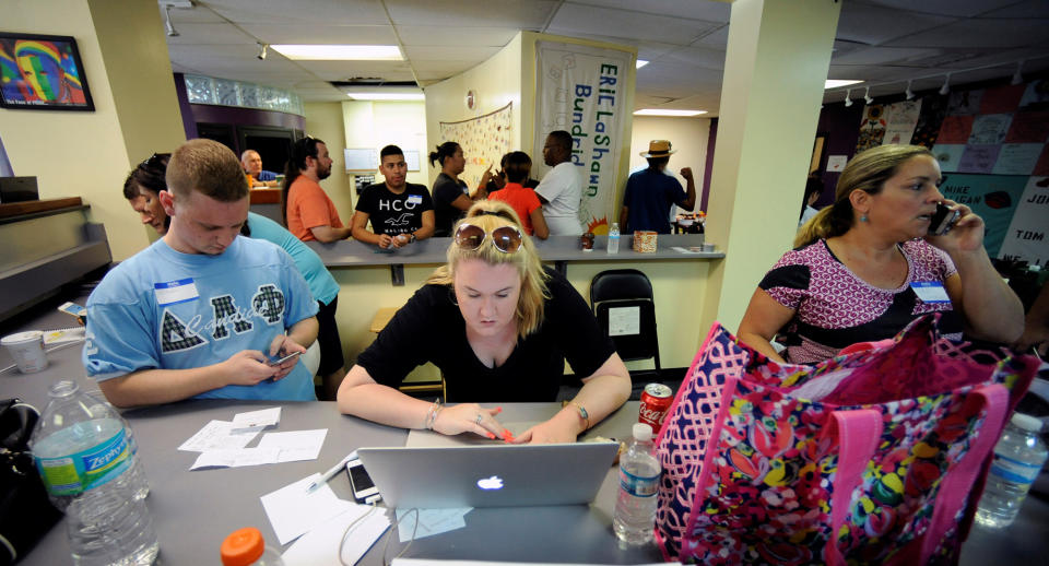 <p>Volunteers Clinton Grubb (L), Brittani Acuff (C) and others gather at The Center, a GLBT organization, to provide assistance and counseling to the community after an early morning shooting attack at a gay nightclub in Orlando, June 12, 2016. (REUTERS/Steve Nesius) </p>