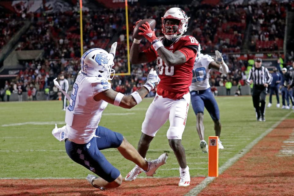 North Carolina State wide receiver Emeka Emezie (86) hauls in a pass for a touchdown next to North Carolina defensive back Cam'Ron Kelly.