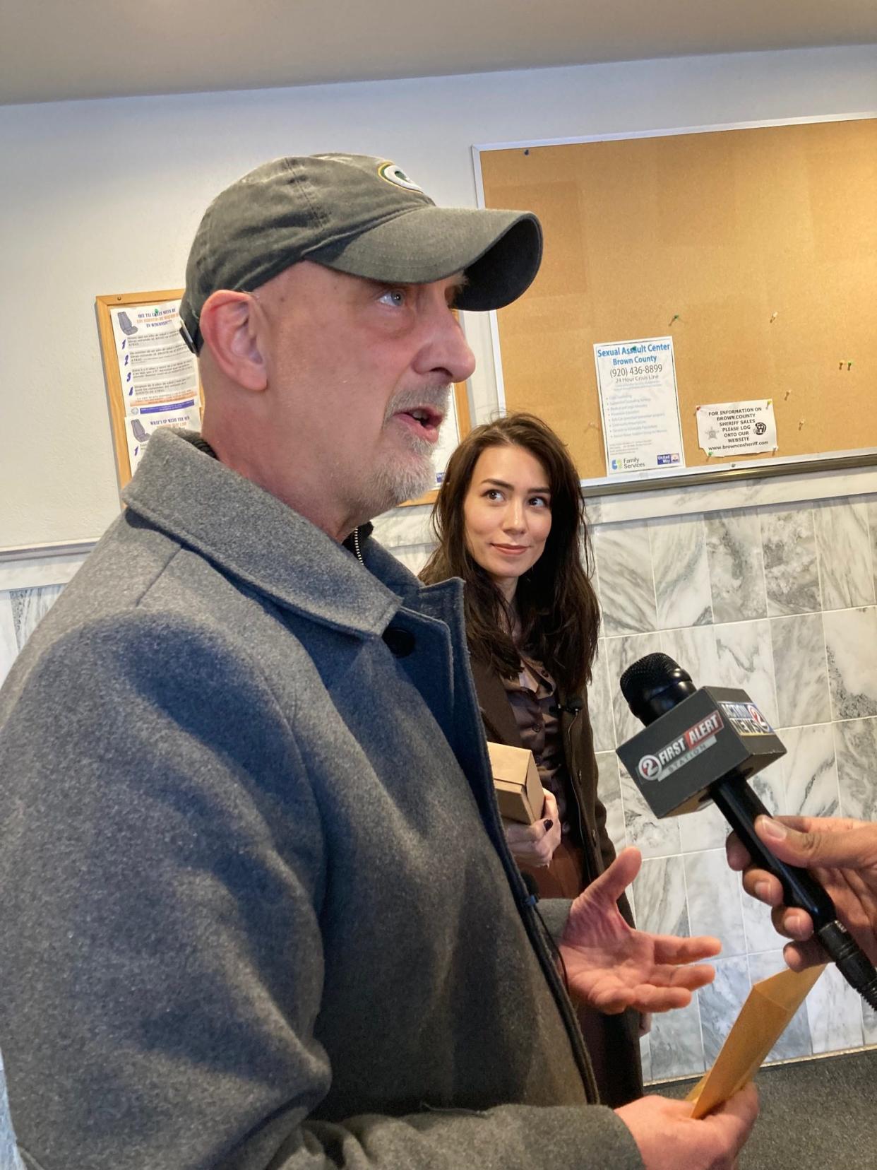 Peter Isely, front, speaks to media about the alleged cover-up he claims has prevented victims from getting justice from the Catholic Church. The documents were left for Brown County District Attorney David Lasee.