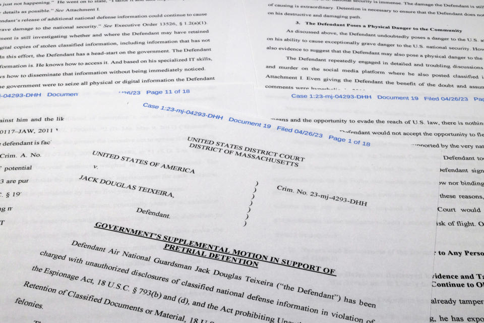 The Justice Department motion for continued pretrial detention of Jack Teixeira is photographed Thursday, April 27, 2023. A judge has put off a decision on whether the Massachusetts Air National guardsman accused of leaking highly classified military documents should be held in jail until his trial. Prosecutors said Teixeira kept an arsenal of weapons and said on social media that he would like to kill a "ton of people." (AP Photo/Jon Elswick)