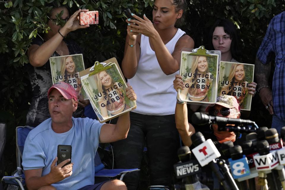 Supporters of Gabby Petito hold up photos of Gabby after a news conference Wednesday, Oct. 20, 2021, in North Port, Fla.