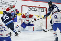 Montreal Canadiens goaltender Jake Allen (34) makes a save as Winnipeg Jets' Blake Wheeler (26) attempts to tip in the rebound during the second period of an NHL hockey game Saturday, Feb. 27, 2021, in Winnipeg, Manitoba. (John Woods/The Canadian Press via AP)