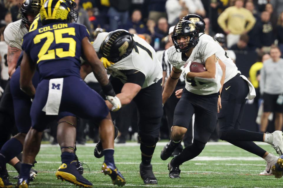 Dec 3, 2022; Indianapolis, Indiana, USA; Purdue Boilermakers running back Devin Mockobee (45) carries the ball during the first half of the Big Ten Championship against the Michigan Wolverines at Lucas Oil Stadium. Mandatory Credit: Trevor Ruszkowski-USA TODAY Sports