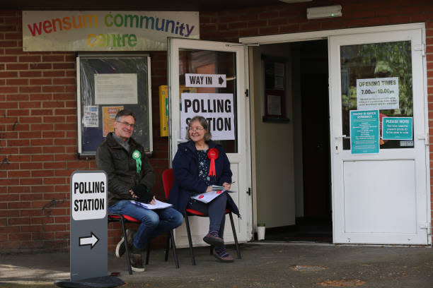 Green and Labour Party tellers sit outside the polling station at Wensum Community Centre as voting opens in the local election on 4 May 2023 in Norwich, United Kingdom (Getty Images)