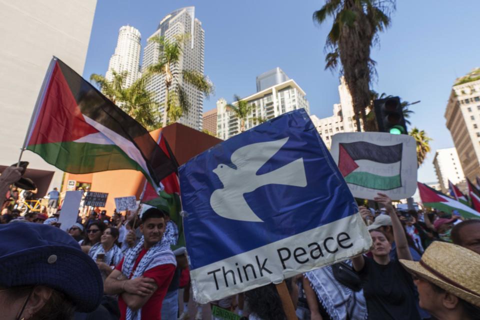 People participate during a pro-Palestinian march calling for a ceasefire in Gaza, Saturday, Oct. 21, 2023, downtown Los Angeles. (AP Photo/Damian Dovarganes)