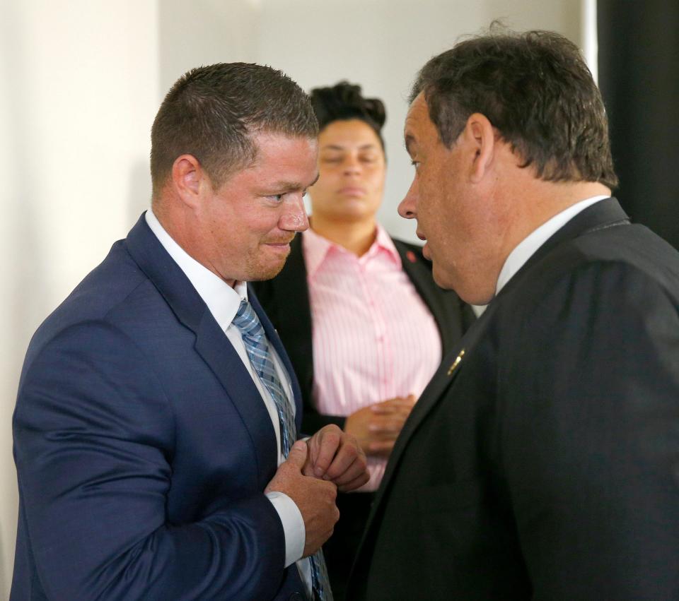 John Brogan, Toms River, speaks with Chris Christie during a break in the “Solutions for a New Way Forward” panel discussion at Jersey Shore University Medical Center in Neptune, Thursday, May 19, 2016.