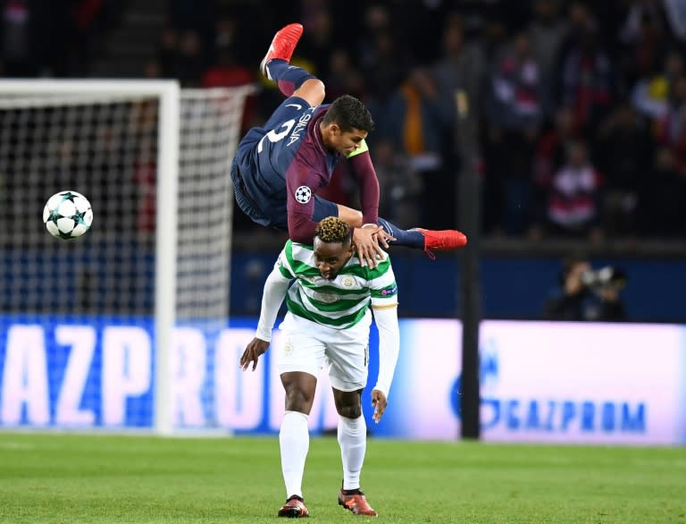 Paris Saint-Germain's defender Thiago Silva (TOP) fights for the ball with Celtic's striker Moussa Dembele during the UEFA Champions League Group B football match November 22, 2017