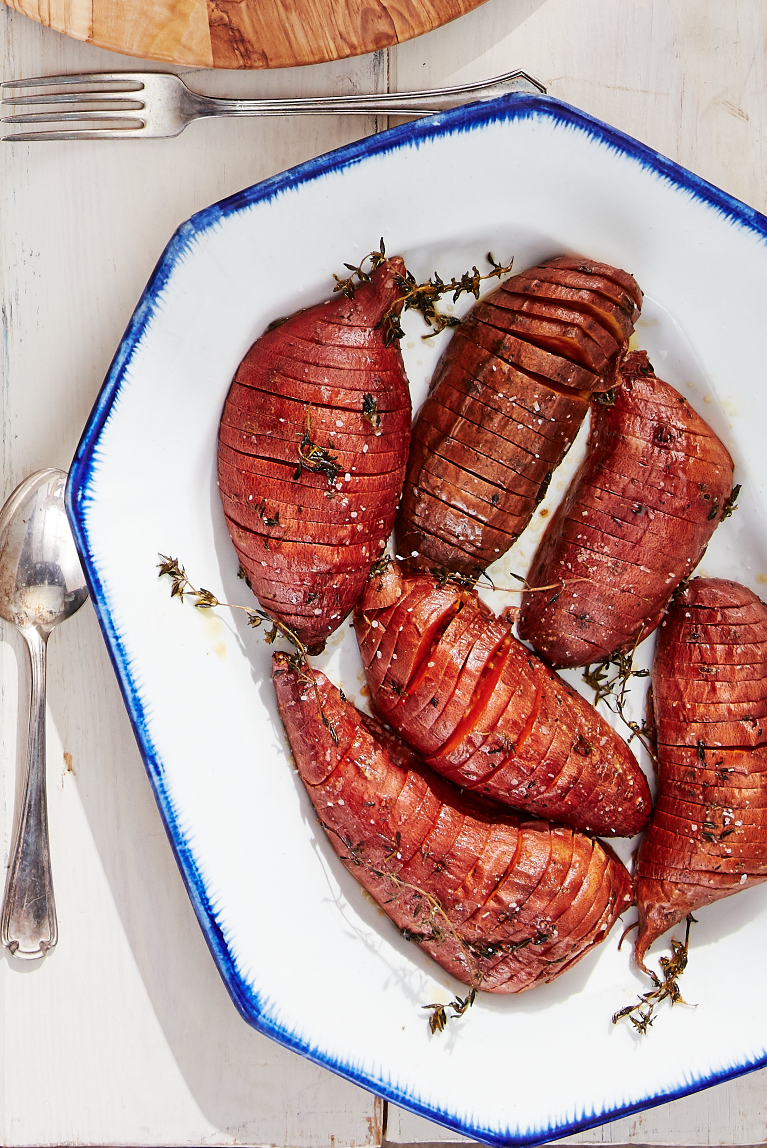 <p>Just imagine how beautiful the rich color of these thyme-scented sweet potatoes will look on a plate next to a slice of your Christmas ham. We can practically see (and smell) it already!</p><p><strong><a href="https://www.countryliving.com/food-drinks/a28942812/roasted-hasselback-sweet-potatoes-recipe/" rel="nofollow noopener" target="_blank" data-ylk="slk:Get the recipe for Roasted Hasselback Sweet Potatoes;elm:context_link;itc:0;sec:content-canvas" class="link ">Get the recipe for Roasted Hasselback Sweet Potatoes</a>.</strong> </p>