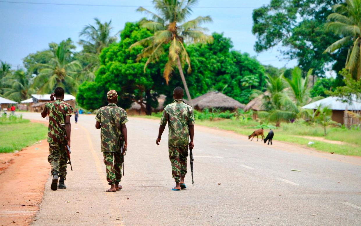 Soldiers from the Mozambican army patrol the streets after security in the area was increased - ADRIEN BARBIER /AFP