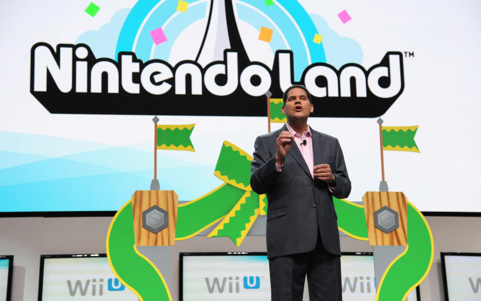 FILE - This June 5, 2012 publicity photo provided by Nintendo shows Reggie Fils-Aime, Nintendo of America's President and Chief Operating Officer, speaking onstage at the Nintendo All-Access Presentation @ E3, in Los Angeles. The loveable green-skinned critter Yoshi and princess-rescuing adventurer Link and are coming the Nintendo 3DS. The Japanese gaming giant announced plans Wednesday, April 17, 2013, to bring “Yoshi’s Island,” “The Legend of Zelda” and “Mario Party” games to its handheld gaming system. (AP Photo/Nintendo, Vince Bucci)