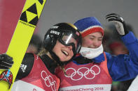 <p>Gold medallist Norway’s Maren Lund (L) is joined by Norway’s Silje Opseth as they celebrate Norway’s win following the women’s normal hill individual ski jumping event during the Pyeongchang 2018 Winter Olympic Games on February 12, 2018, in Pyeongchang. / AFP PHOTO / Christof STACHE </p>