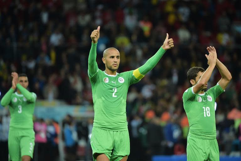 Algeria defender and captain Madjid Bougherra (C) gestures to the crowd after losing their Round of 16 football match against Germany at Beira-Rio Stadium in Porto Alegre during the 2014 FIFA World Cup on June 30, 2014