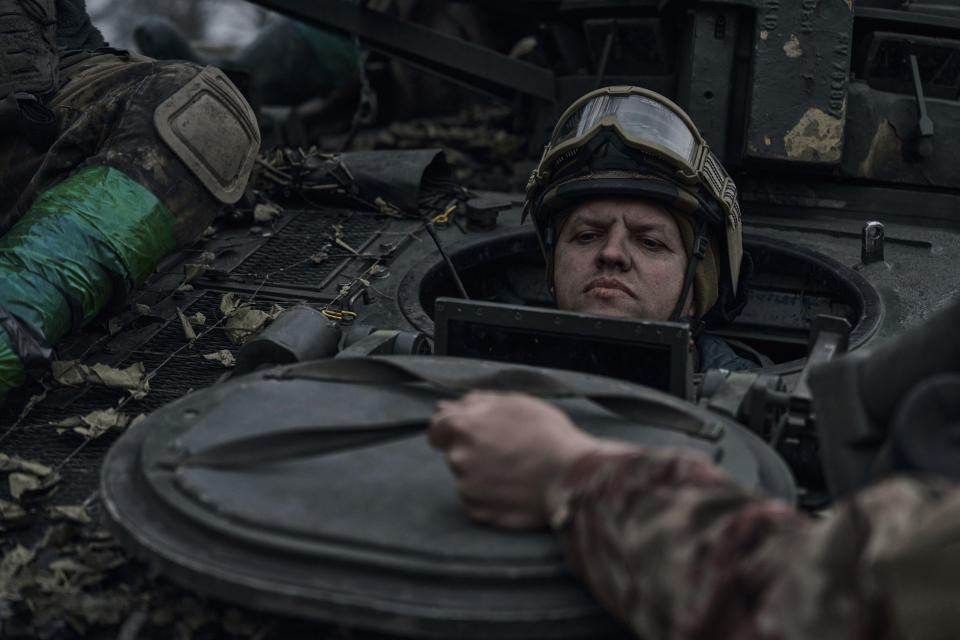 A Ukrainian soldier looks out of the APC on the frontline in Bakhmut, Donetsk region, Ukraine, Saturday, April 8, 2023. (AP Photo/Libkos)