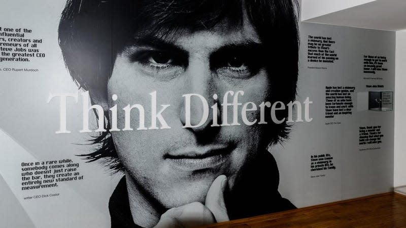 A picture of Steve Jobs with the words "Think Different" in front of him