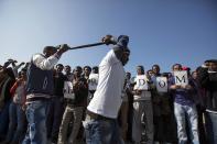 African migrants gesture as they take part in a protest outside the U.S. embassy in Tel Aviv January 6, 2014. Several thousand African migrants protested outside Western embassies in Tel Aviv on Monday, demanding freedom for compatriots jailed by Israel in a desert facility under a new open-ended detention law. REUTERS/Baz Ratner(ISRAEL - Tags: POLITICS SOCIETY IMMIGRATION CIVIL UNREST)