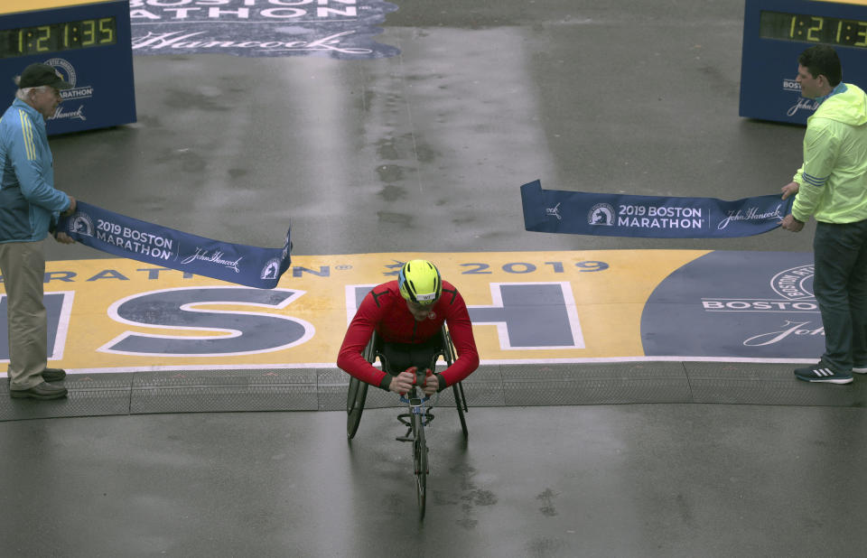 Daniel Romanchuk, of Urbana, Ill., breaks the tape to win the men's handcycle division of the 123rd Boston Marathon on Monday, April 15, 2019, in Boston. (AP Photo/Charles Krupa)