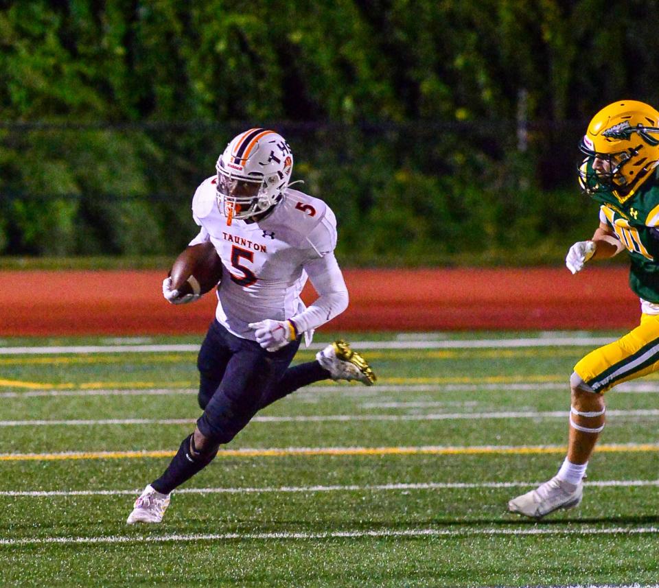 Taunton’s Dmitius Shearrion returns the opening kickoff during Friday’s game against King Philip.