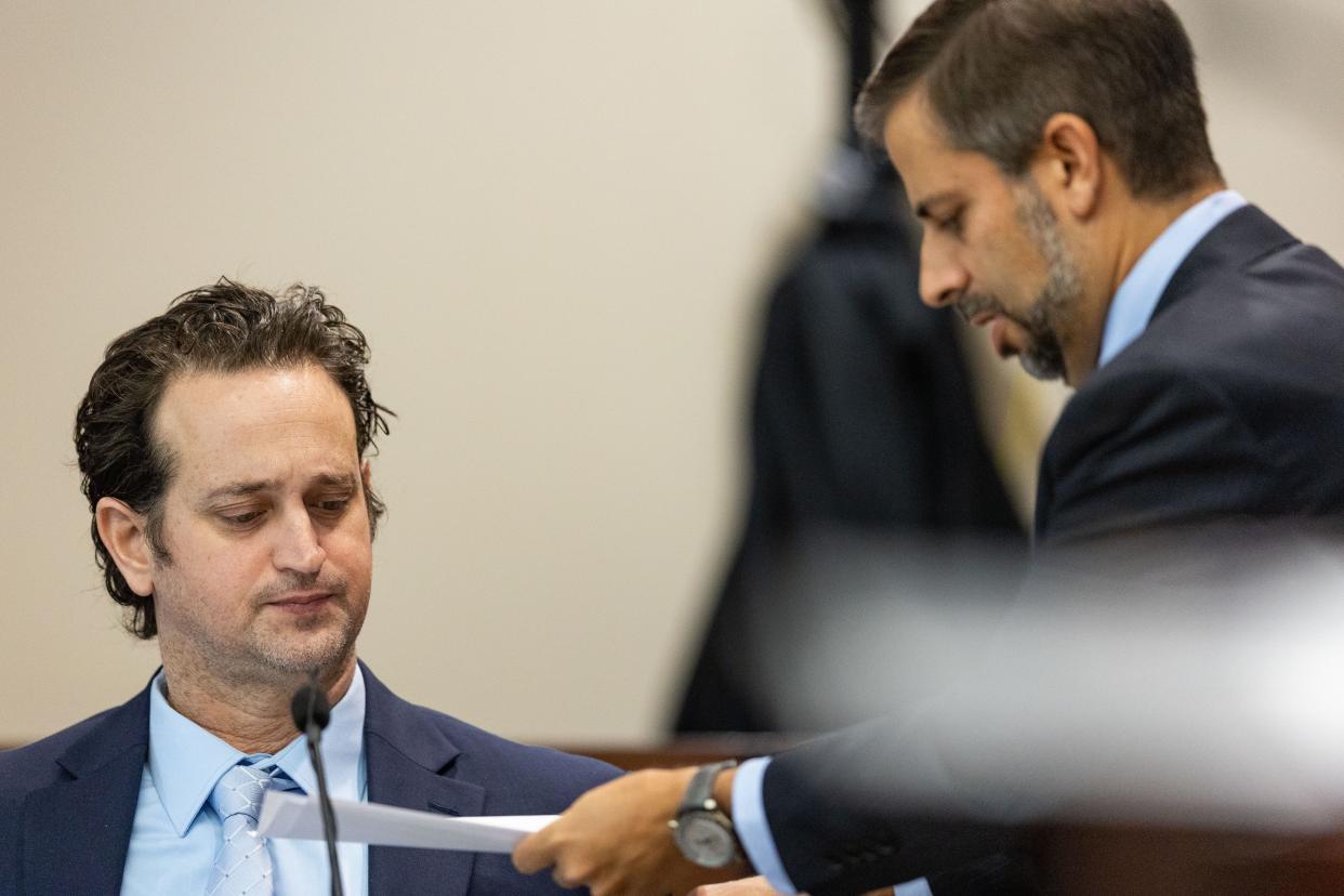 Defense attorney Daniel Rashbaum shows his client Charlie Adelson, copies of texts between him and Katherine Magbanua, Thursday, Nov. 2, 2023.