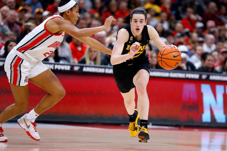 Iowa guard Caitlin Clark, right, dribbles past Ohio State forward Taylor Thierry during the first half of last season's matchup at Value City Arena between the Hawkeyes and Buckeyes.