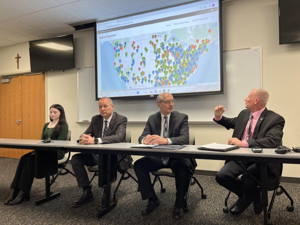 Mitch Kajzer, right, gestures to a map of malware attacks made by Magnet Forensics during a press conference at Notre Dame on Wednesday April 5, 2023.