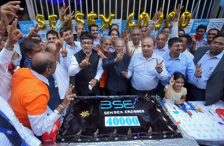 Ashishkumar Chauhan, MD and CEO of the Bombay Stock Exchange (BSE), gestures along with other employees before cutting a cake to celebrate the Sensex index rising to over 40,000, in Mumbai, India, May 23, 2019. REUTERS/ Francis Mascarenhas