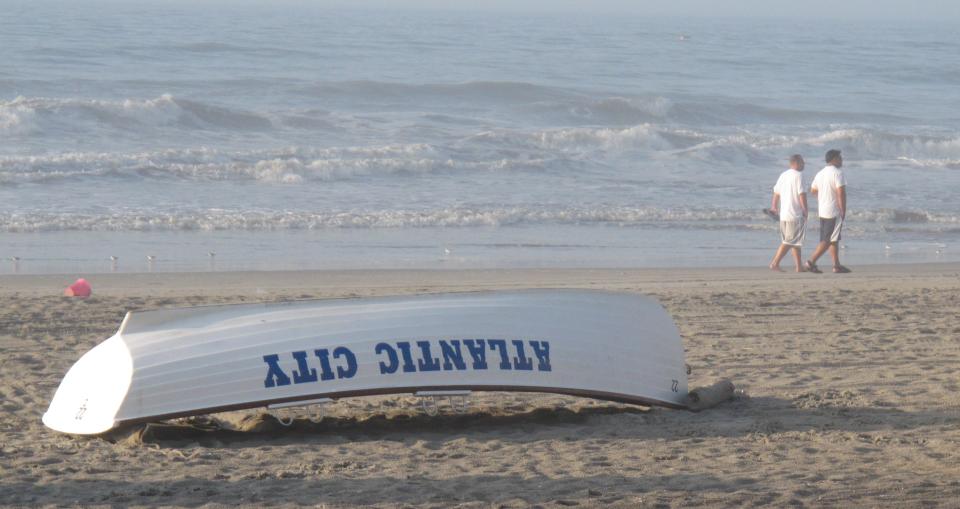 Men walk on the beach in Atlantic City N.J. on Aug. 26, 2011. The Atlantic City Alliance has launched a new "Do Change" advertising campaign to promote things to do in the fall. (AP Photo/Wayne Parry)