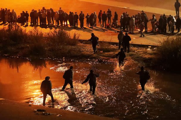 PHOTO: Migrants travelling in a caravan of more than a thousand people cross the Rio Bravo river (or Rio Grande river, as it is called in the US) to ask for political asylum in the United States, in Ciudad Juarez, Chihuahua state, Mexico, Dec. 11, 2022. (Herika Martinez/AFP via Getty Images)