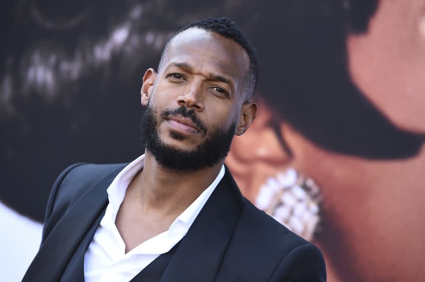 Marlon Wayans looks up with a slightly furrowed brow during a movie premiere