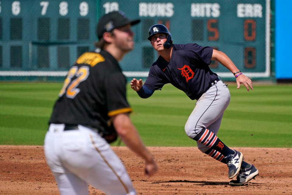 Detroit Tigers' Spencer Torkelson, right, takes off from second as he and Pittsburgh Pirates pitcher Sean Poppen watch a batted ball during the third inning of a spring training baseball game in Bradenton, Fla., Tuesday, March 2, 2021.