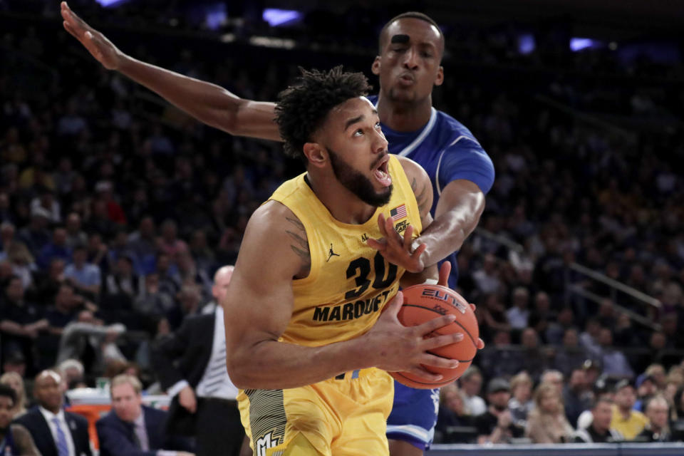 Marquette forward Ed Morrow (30) drives against Seton Hall center Romaro Gill (35) during the first half of an NCAA college basketball semifinal game in the Big East men's tournament, Friday, March 15, 2019, in New York. (AP Photo/Julio Cortez)
